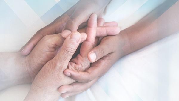 Close up image of holding hands